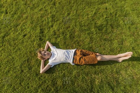 Teenage Boy Lying In Grass Stock Photo Offset