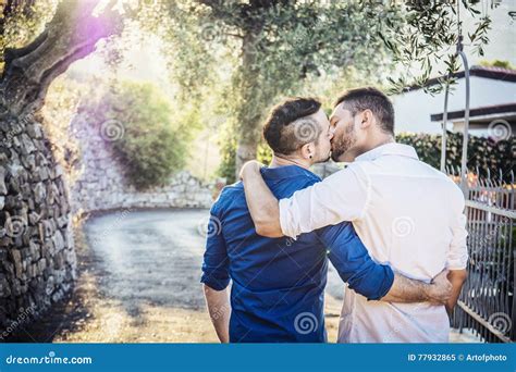 Gay Couple Walking In Park And Kissing Stock Image Image Of