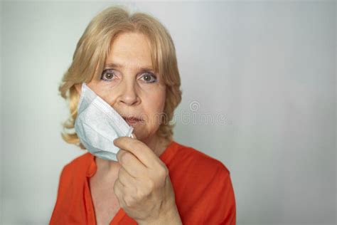 closeup portrait shot of older woman taking off face mask stock image image of older medical