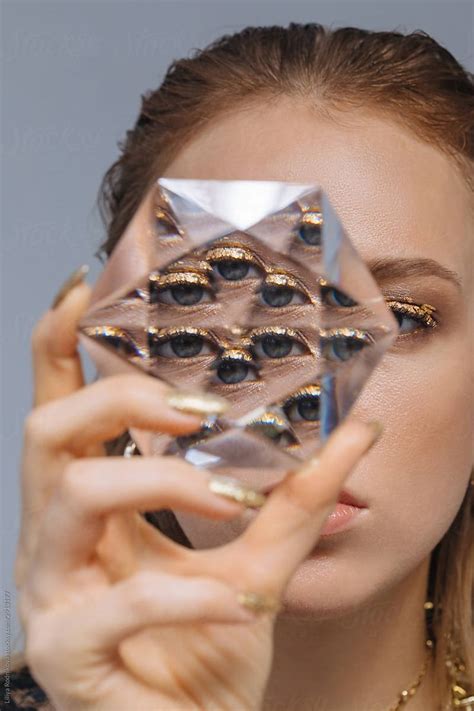 Woman With Glitter Makeup Looking Through Glass Prism By Stocksy Contributor Liliya Rodnikova