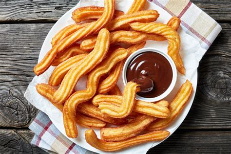 So easy to make but just so delicious!▼. Traditional Spanish Dessert Churros On A White Platter Stock Photo - Download Image Now - iStock