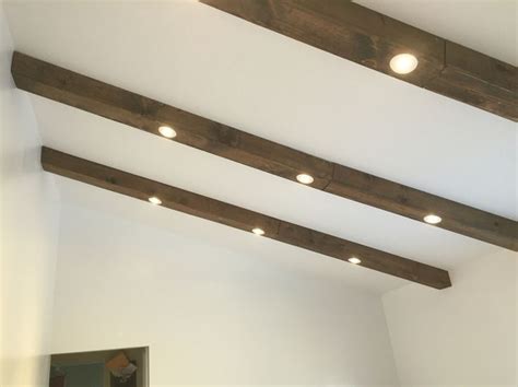 Watch your fingers, as a sharp metal clip will pop downward from the edge as the fixture emerges. Faux wood beams with recessed lights | Ceiling beams ...