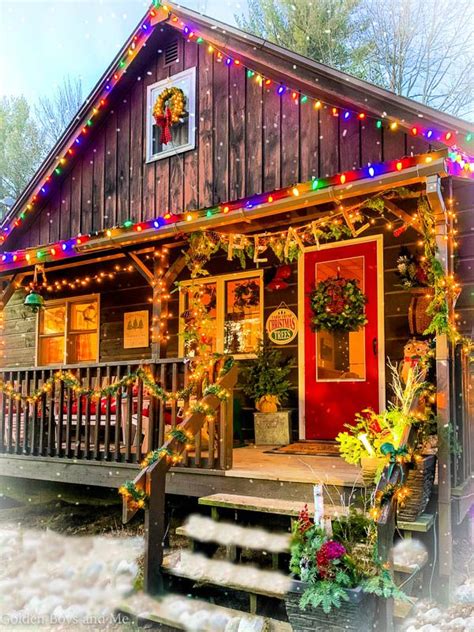 Cabin With Christmas Decorations On The Porch