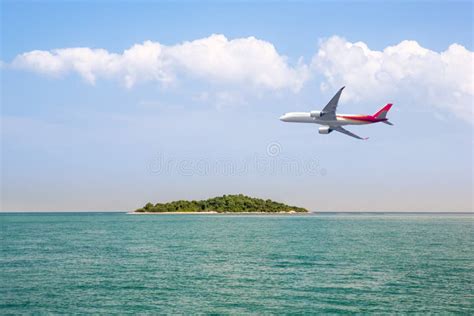 Passenger Plane Flying Over Beautiful Blue Ocean And Island Sea Beach