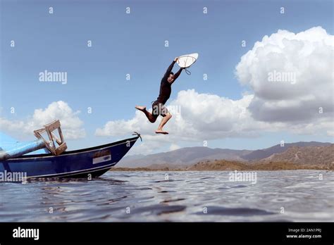 Man Jumping From Boat Into Sea Stock Photo Alamy