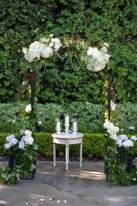 White Hydrangea And Greenery Accented Wedding Arch