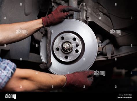 Car Mechanic Repairing Brakes On Car Stock Photo Alamy