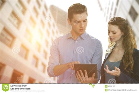 Composite Image Of Concentrated Business People Using A Digital Tablet