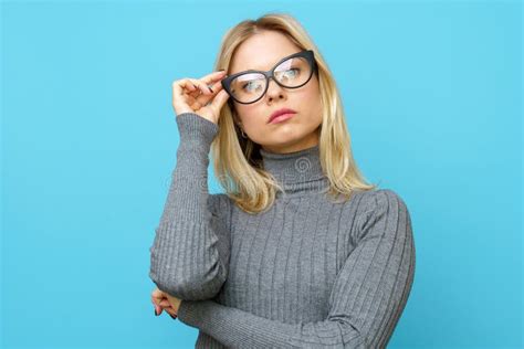 Photo Of Blonde In Glasses On Empty Blue Background Stock Image Image