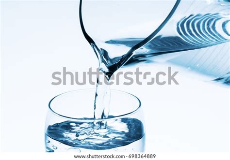 Pouring Water Into Glass Stock Photo 698364889 Shutterstock