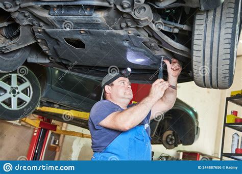 Auto Mechanic Repairman At Work Stock Photo Image Of Tighten