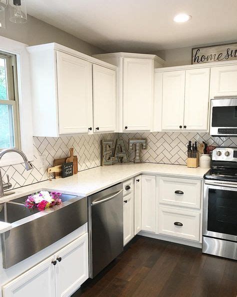 High contrast kitchen cabinets with black accents this kitchen is such a nice design both antique and farmhouse style. White kitchen, kitchen decor, subway tile, herringbone ...