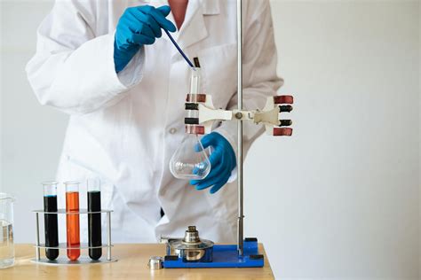 Faceless Laboratory Technician Conducting Chemical Test · Free Stock Photo