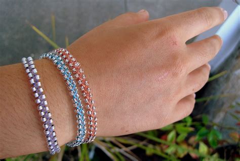 If your hair is longer than the tool, you can extend the braid all the way to the end of your ponytail with a regular fishtail braid if you prefer, or you can stop at the last bead like we did. Beaded Braid Bracelet | dianne faw