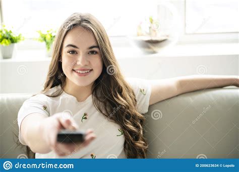 A Teenage Girl Relaxing At Home Watching Television Stock Photo Image