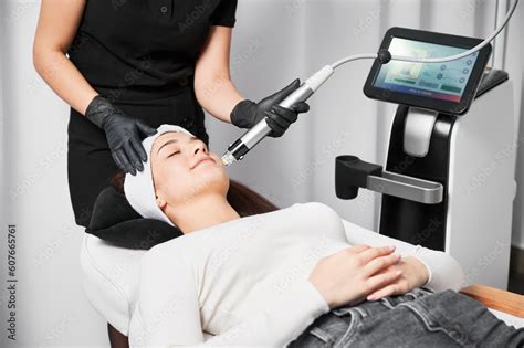 Doctor Beautician Using Radiofrequency Microneedling Device While