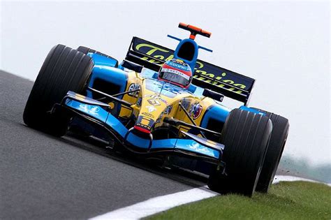 A Blue And Yellow Race Car Driving On A Track
