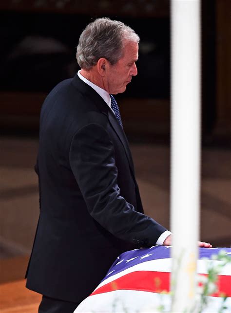 video george w bush appears to sneak michelle obama candy at george hw bush s funeral abc30