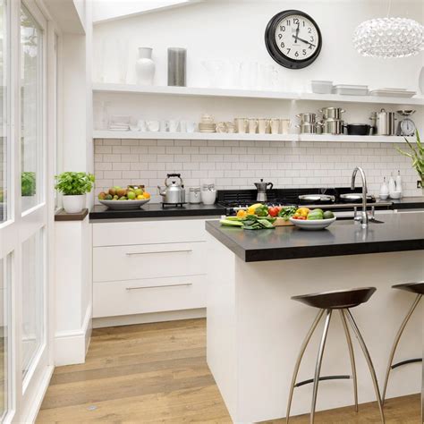 The contemporary kitchen in the picture above features stainless steel appliances which can easily be integrated with the neutral dark brown cabinets and white quartz counter. Black & white kitchen with open shelving - think white ...