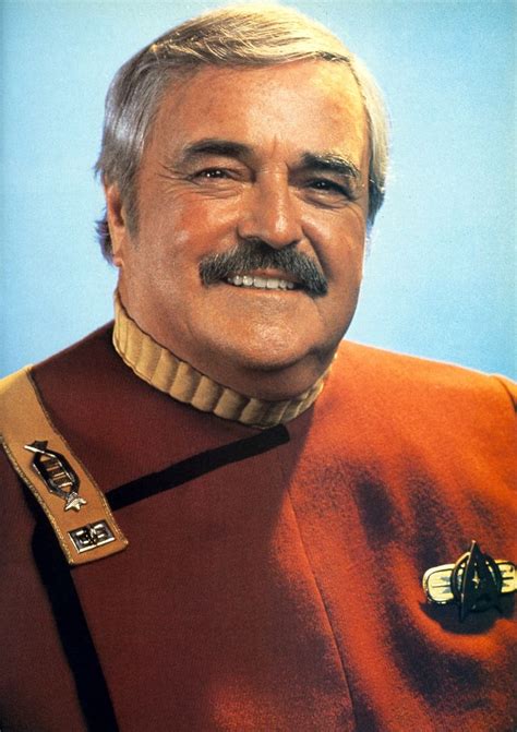 An Older Man With A Mustache Wearing A Star Trek Uniform