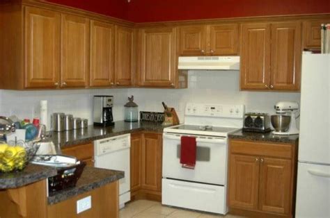 White appliances with colorful cabinets. oak kitchen cabinets with white appliances and granite ...