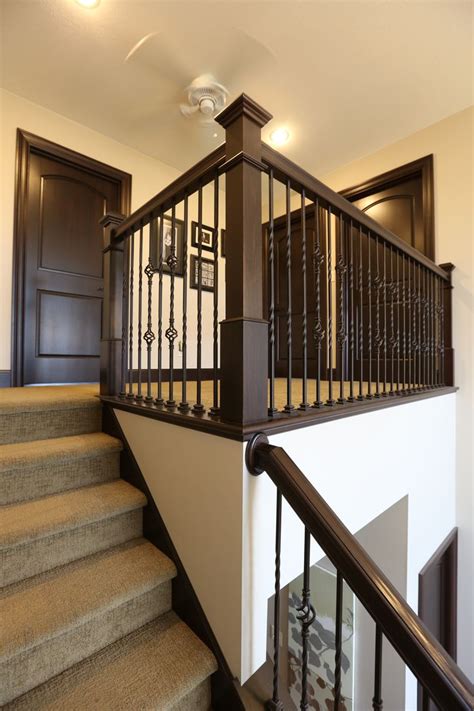 Turn a beautiful staircase into a stunning staircase with our solid metal stair spindles. Stair Systems | dark stain, with wrought iron balusters | Bayer Built Woodworks, Inc ...