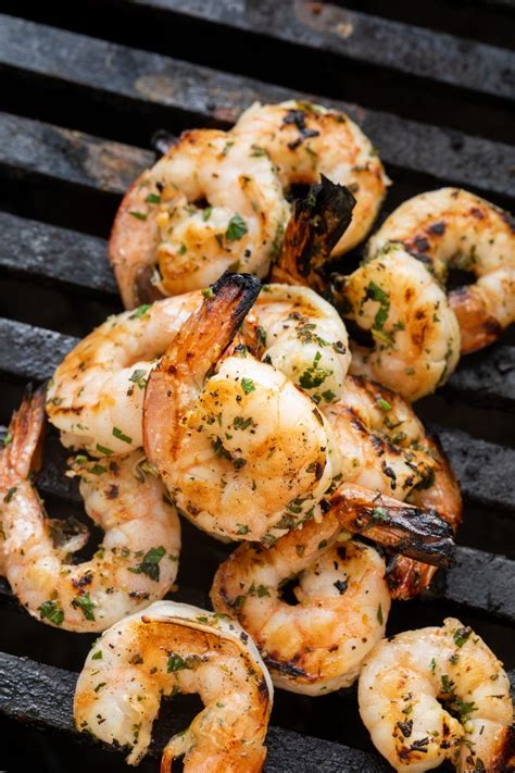 Marinated grilled shrimp recipes you'll make on repeat get ready to fire up the grill! marinated shrimp on the grill grates of a grill in 2020 ...
