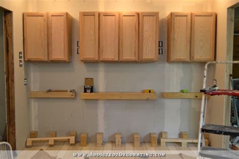 How to install kitchen cabinets. Wall Of Cabinets Installed (Plus, How To Install Upper ...