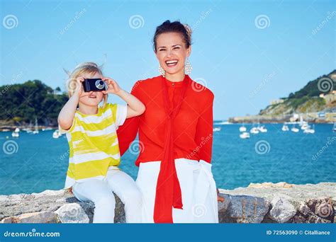 Happy Mother And Child Taking Photo In Front Of Lagoon Stock Photo