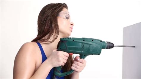 Sexy Girl Drills With A Drill On A White Studio Concept Beauty And
