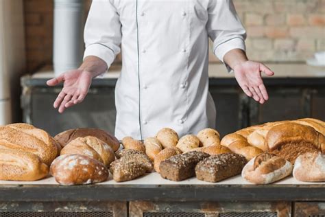 Premium Photo Baker S Hand Showing Various Baked Breads