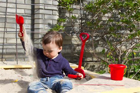 Active Little Boy On Playground Playing Child In Sandbox Stock Image