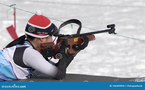 sportswoman biathlete aiming rifle shooting prone position south korea biathlete choi yoonah