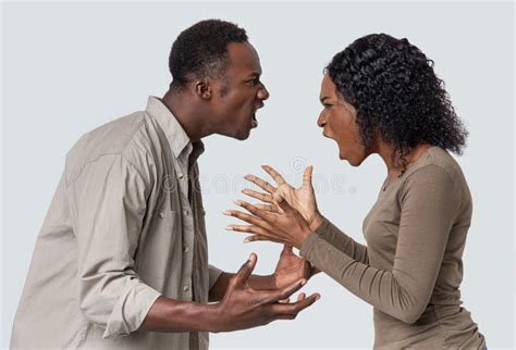 Angry Black Man And Woman Fighting Over Grey Background Stock Image