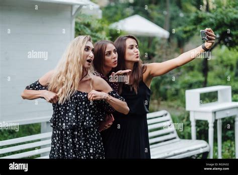 Three Girls Make Selfies Stock Photo Alamy