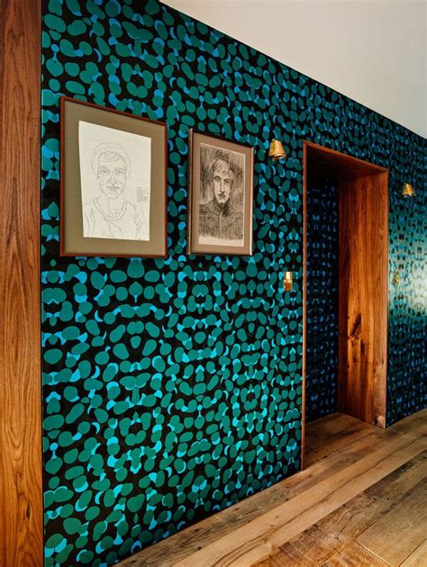 A Room With Blue And Green Wallpaper Pictures On The Wall And Wooden