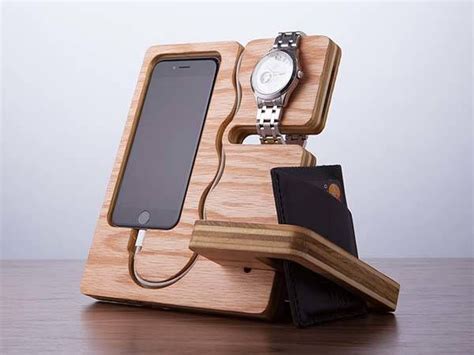 An Iphone Charging Station With A Wallet Watch And Cell Phone On Its