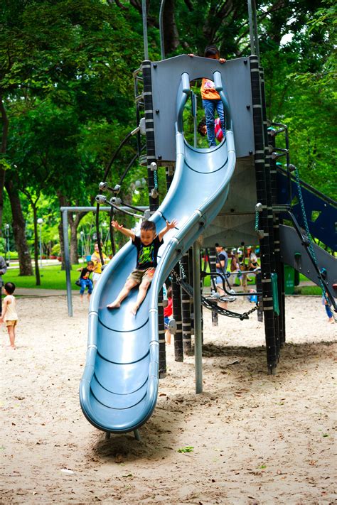 Boy Playing On Slide In Playground · Free Stock Photo