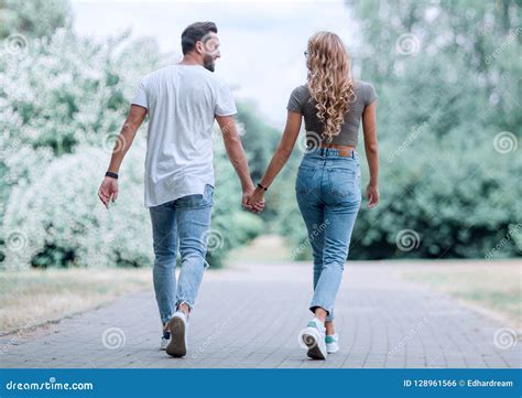 Couple In Love Walking In Park Holding Hands Stock Photo Image Of