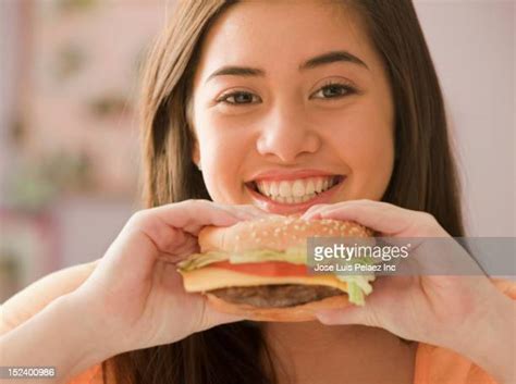Girl Eating Cheeseburger Photos And Premium High Res Pictures Getty Images