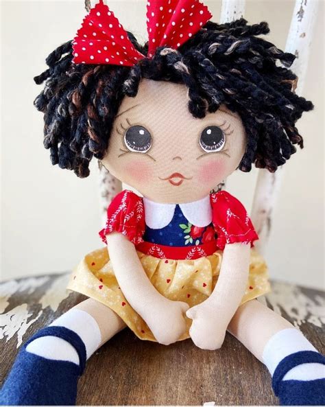 A Doll Sitting On Top Of A Wooden Table