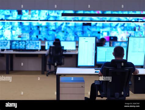 Male Security Operator Working In A Data System Control Room Offices