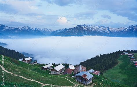 Traditional Wooden Houses And Sea Of Clouds With Snowy Mountain