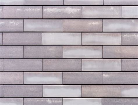 Begin laying your first row of brick pattern tiles at the center of the room. How to Create Popular Tile Patterns | STL Tile Company