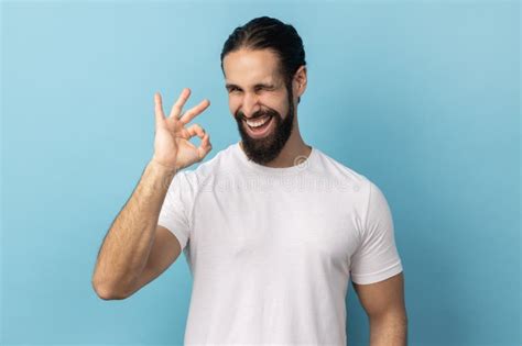 Man Standing Looking At Camera Showing Ok Sign Gesture Expressing