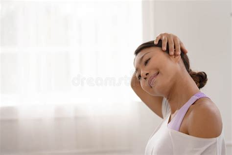 Asian Woman Exercises In The Fitness Studio Practice Neck Stretching