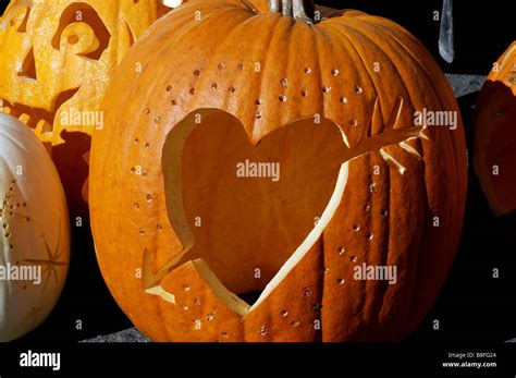 A Pumpkin With A Love Heart And Arrow Carved In It Stock Photo Alamy