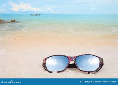 Holiday Travel Sunglasses On Sand Beach And Sun Reflect Stock Photo