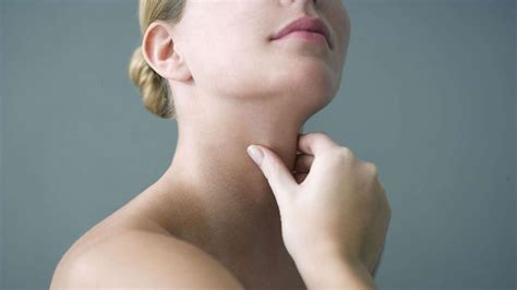 Breast cancer awareness ribbon on the blue wooden background. Thyroid Cancer Awareness Month: How to check for the ...