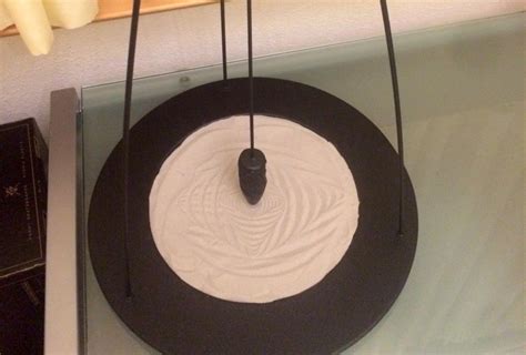 A Sand Pendulum Is A Decorative Piece That Relies On Momentum To Furrow